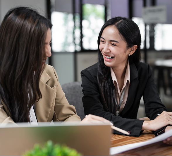 businesswomen-discussing-financial-reports-office 1