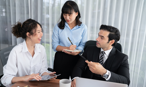 businesswomen-discussing-financial-reports-office 1