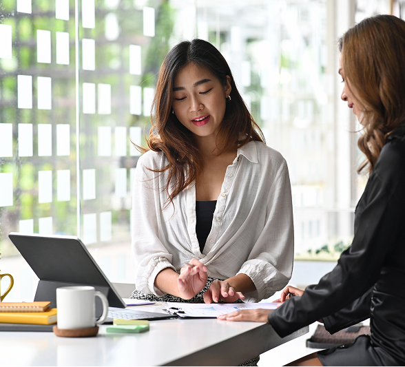 businesswomen-discussing-financial-reports-office 1