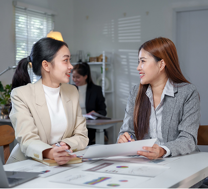 businesswomen-discussing-financial-reports-office 1
